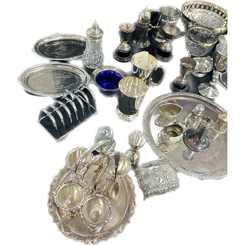 191 - Large selection of silver plated ware includes candle sticks, toast rack, egg cups etc