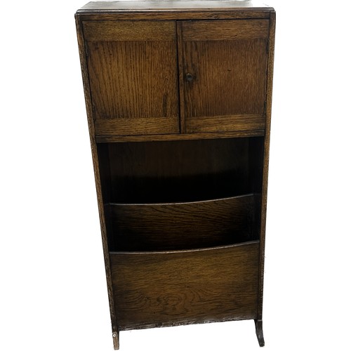 382 - Oak two door book case with magazine rack measures approximately 33 inches tall x 15 wide and 7 deep