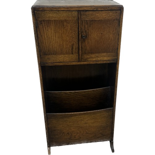 382 - Oak two door book case with magazine rack measures approximately 33 inches tall x 15 wide and 7 deep