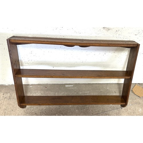 353 - Oak wall hanging plate rack measures approximatley 27 inches tall x 5 inch deep and 3 foot wide