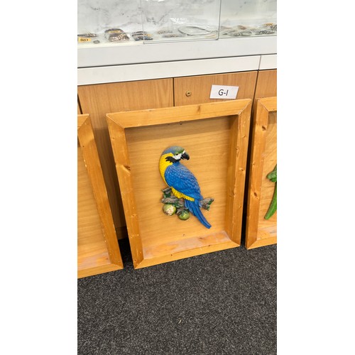 302 - Four wooden framed 3D parrot wall plaques largest measures approximately 27 inches tall x 17 wide