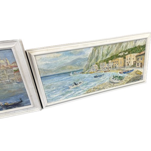 10 - Two white framed paintings depicting sea side town scenes largest measures approximately 30 inches w... 