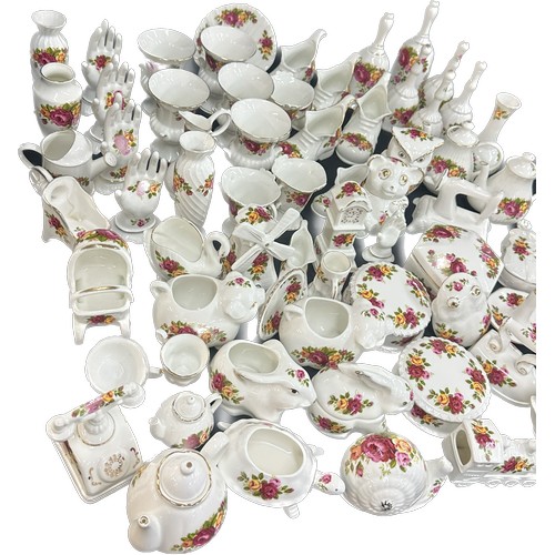 196 - Large selection of individual cottage rose porcelain items to include animal ornaments, ring trees, ... 