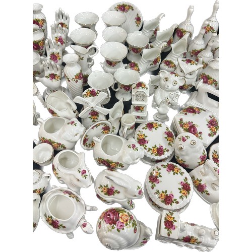 196 - Large selection of individual cottage rose porcelain items to include animal ornaments, ring trees, ... 