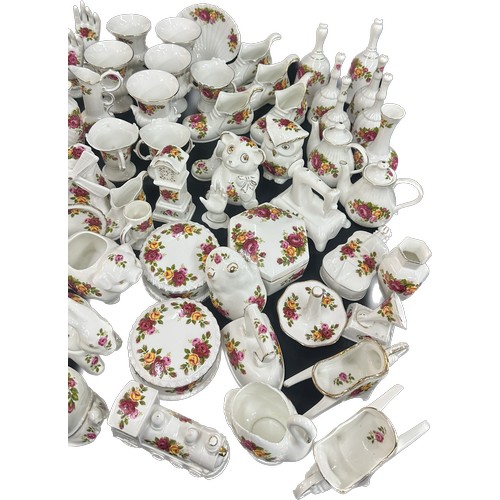 196 - Large selection of individual cottage rose porcelain items to include animal ornaments, ring trees, ... 