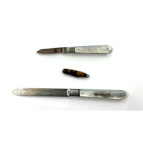 423 - 2 Vintage pocket knifes and a vintage letter opener one mother of pearl with a silver handle, one to... 