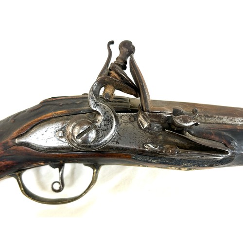 581 - Antique walnut and brass flint lock pistol