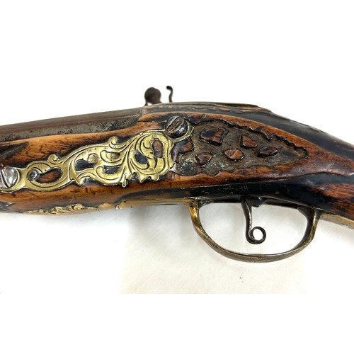 581 - Antique walnut and brass flint lock pistol