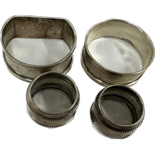 469 - Four silver napkin rings two small ones, one Dutch