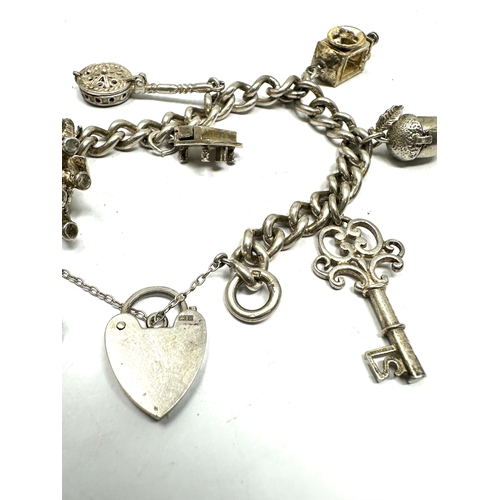 239 - vintage silver charm bracelet with opening charms weight 50g