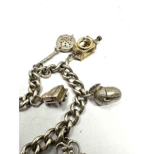 239 - vintage silver charm bracelet with opening charms weight 50g