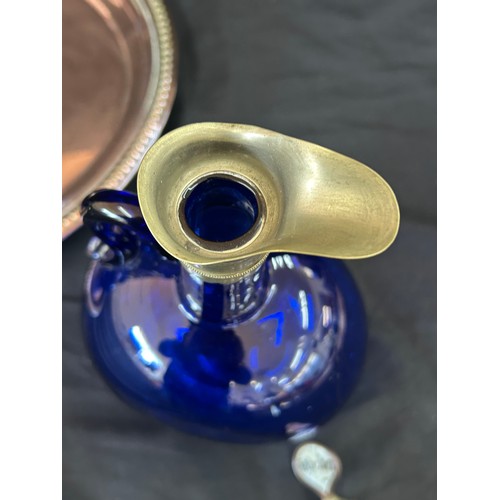 79 - Two vintage blue glass decanters on a copper tray