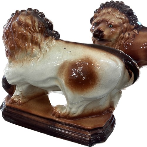 73 - Two vintage porcelain lions overall height 11 inches tall x 14 long, makers mark to bottom