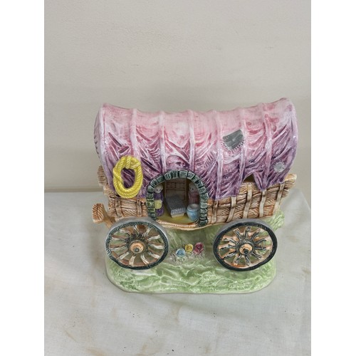 42 - Porcelain gypsy carriage measures approximately 7 inches tall by 8 inches wide