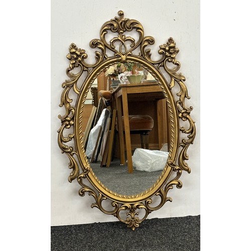 62 - Gilt framed wall hanging mirror measures approximately 36 inches tall 21 inches wide