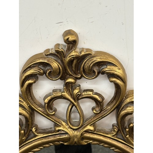 62 - Gilt framed wall hanging mirror measures approximately 36 inches tall 21 inches wide