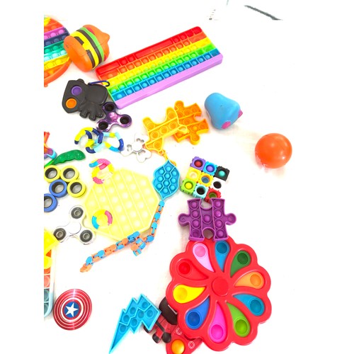 145 - Large selection of assorted fidget toys includes pop its etc