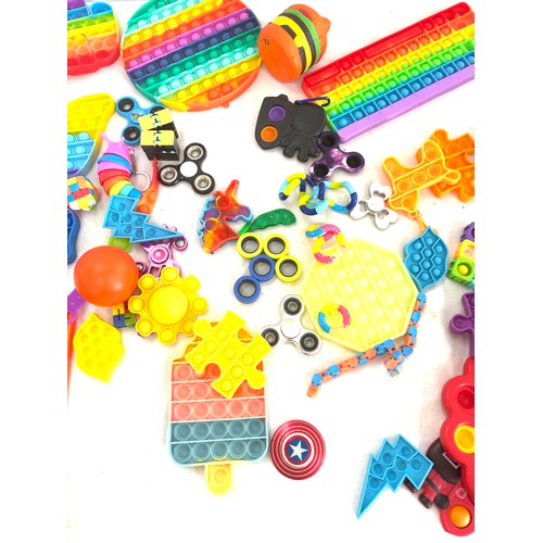 145 - Large selection of assorted fidget toys includes pop its etc