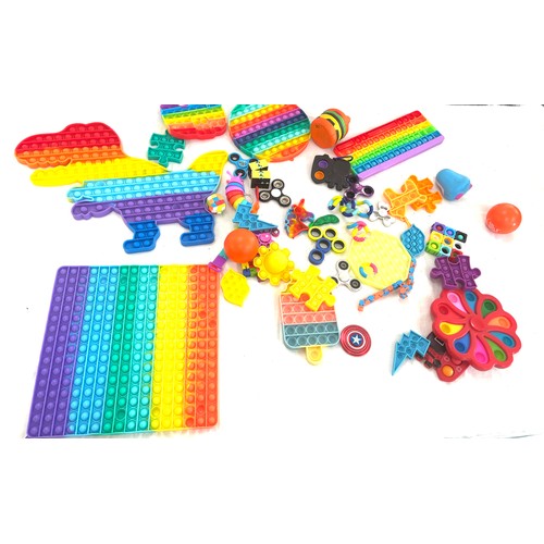 145 - Large selection of assorted fidget toys includes pop its etc