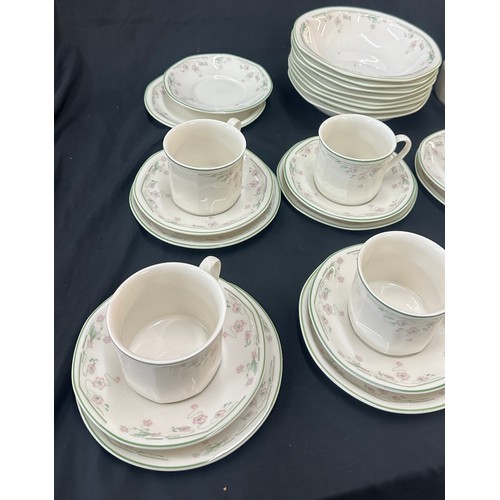 207 - Royal Doulton Caprice pattern to include 9 cups and saucers, a milk jug, dinner plates and bowls