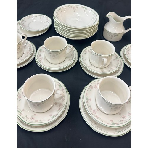 207 - Royal Doulton Caprice pattern to include 9 cups and saucers, a milk jug, dinner plates and bowls