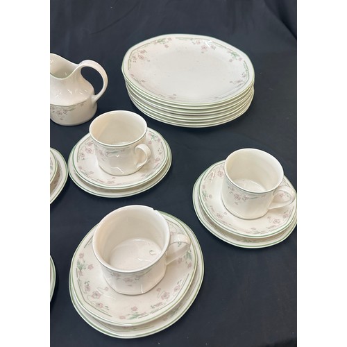 207 - Royal Doulton Caprice pattern to include 9 cups and saucers, a milk jug, dinner plates and bowls
