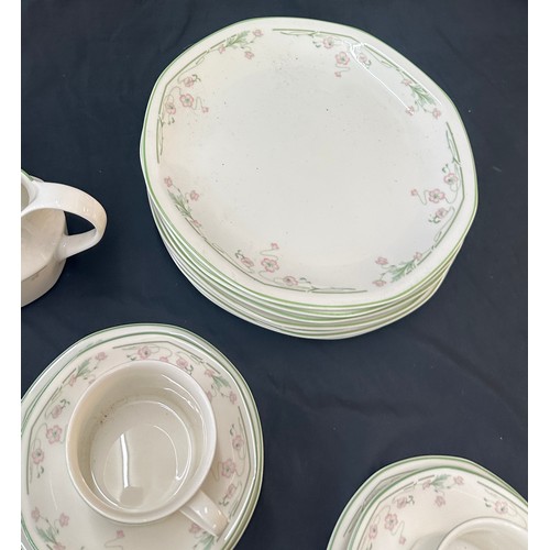 207 - Royal Doulton Caprice pattern to include 9 cups and saucers, a milk jug, dinner plates and bowls