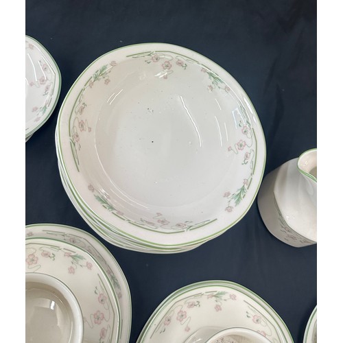 207 - Royal Doulton Caprice pattern to include 9 cups and saucers, a milk jug, dinner plates and bowls