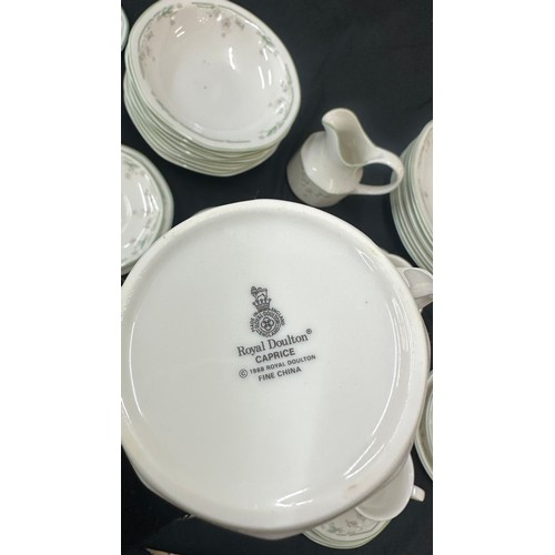 207 - Royal Doulton Caprice pattern to include 9 cups and saucers, a milk jug, dinner plates and bowls