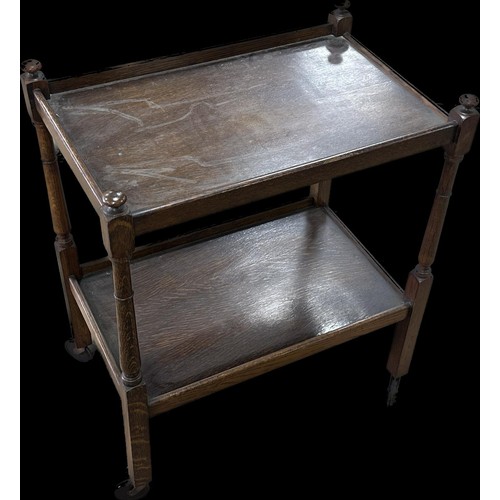 242 - Oak two tier tea trolley measures approximately 32 inches tall x 25 long and 17 deep