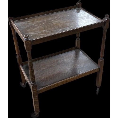 242 - Oak two tier tea trolley measures approximately 32 inches tall x 25 long and 17 deep
