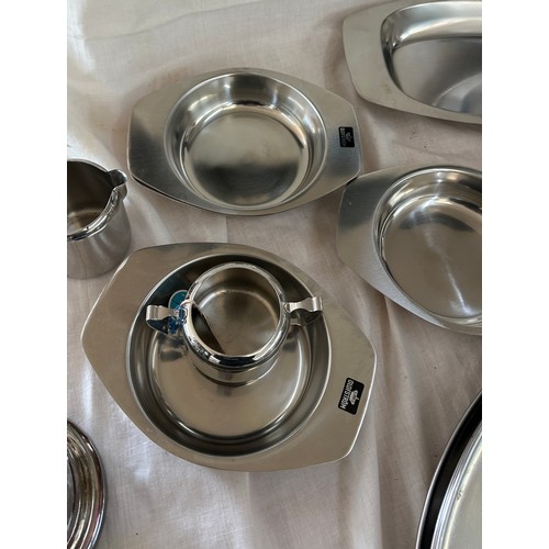 180 - Selection of metalware items to include stainless steel meat trays, a metal fondue stove etc