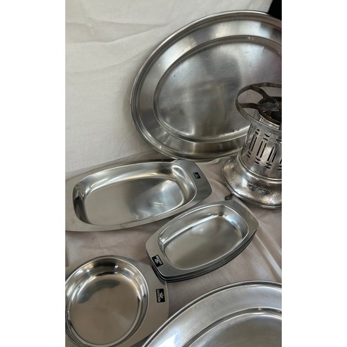 180 - Selection of metalware items to include stainless steel meat trays, a metal fondue stove etc