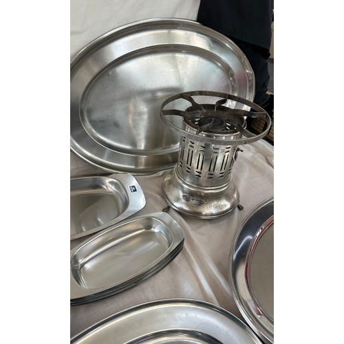 180 - Selection of metalware items to include stainless steel meat trays, a metal fondue stove etc