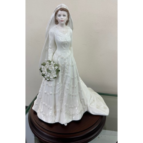 585 - Two Coalport lady bride figurines ' The Queen' and ' Queen Mary' both on wooden plinths, approximate... 