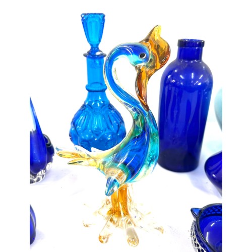 202 - Selection of Blue glassware includes Vases, duck, decanters etc tallest vase measures 21 inches tall