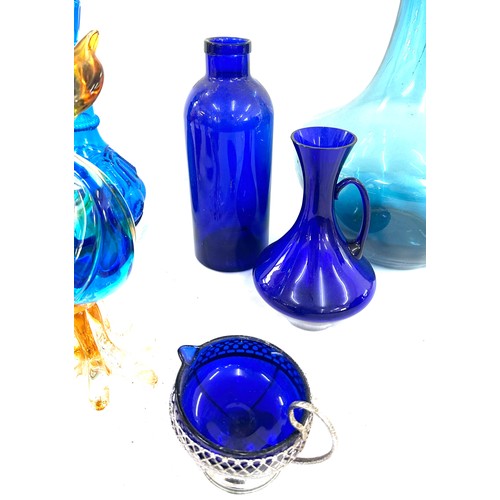 202 - Selection of Blue glassware includes Vases, duck, decanters etc tallest vase measures 21 inches tall