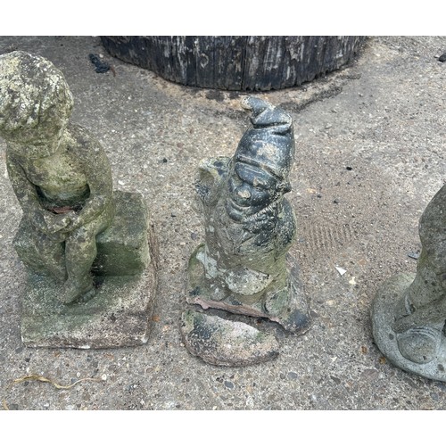 101C - 3 Concrete garden ornaments to gnomes and a boy on a wall, largest measures approximately 16 inches ... 