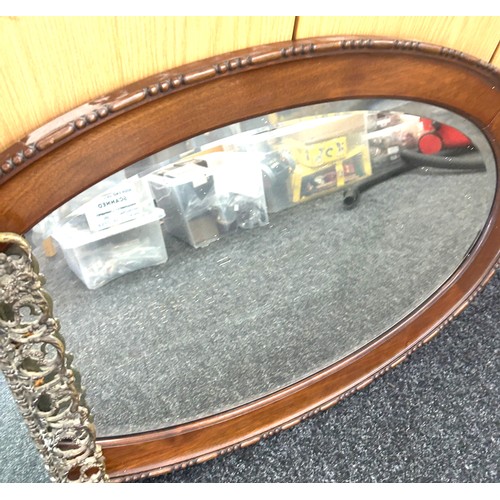 107 - 2 Oval framed mirrors and one other largest measures approximately 33 x 22 inches