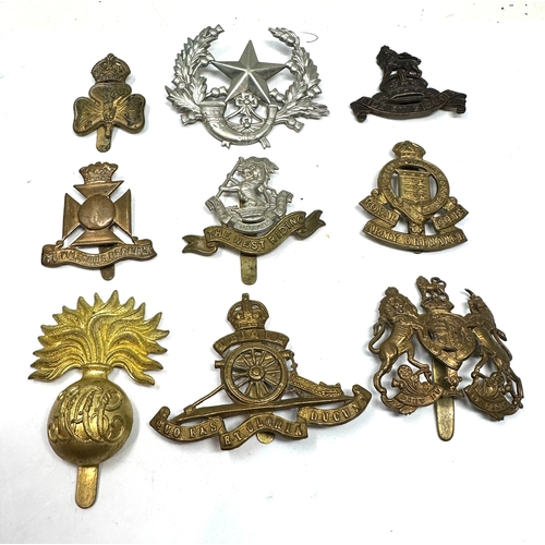 329 - 9 military cap badges