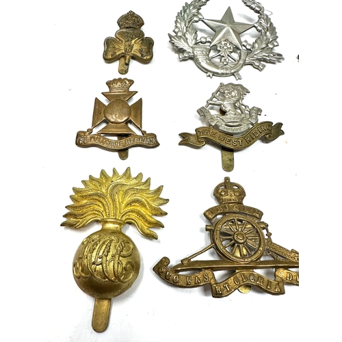 329 - 9 military cap badges