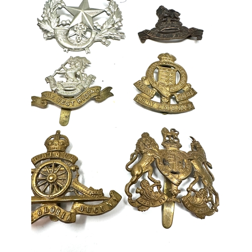 329 - 9 military cap badges