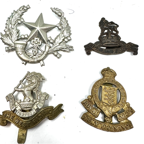 329 - 9 military cap badges