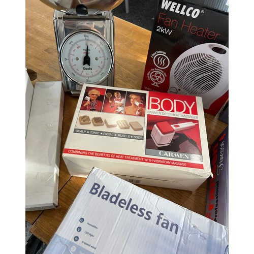 124 - Selection of boxed electrical items to include a bladeless fan, fan heaters, landline phones, body m... 