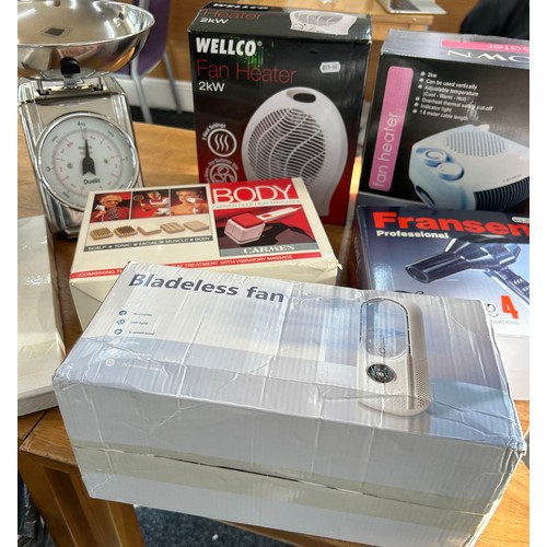 124 - Selection of boxed electrical items to include a bladeless fan, fan heaters, landline phones, body m... 