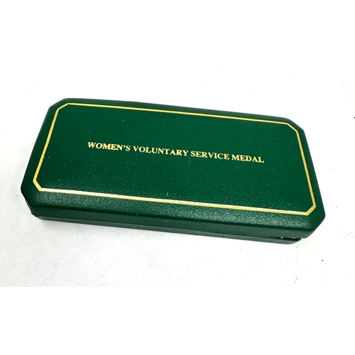 384 - Boxed Women's Royal Voluntary Service (WRVS) medal and badges set. 
The set includes the full-size W... 