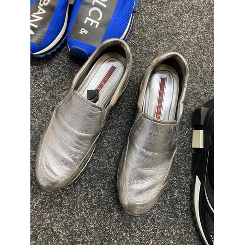 199 - Two pairs of Dolce and Gabbana trainers and a pair of Prada shoes.