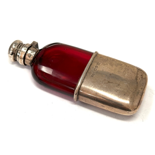 Antique silver &  cranberry hip flask featuring a deep red cranberry glass body with a removable silver drinking cup at the base chester silver hallmarks flask measures approx 11.5cm