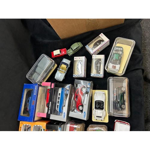 Selection of assorted boxed model cars and a Scalextric track