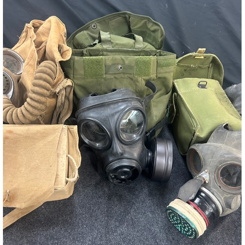 Selection of WW2 gas masks, some in original packaging and bags